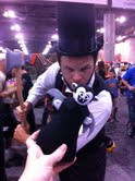 A man dressed as Abraham Lincoln: Vampire Hunter poses with a Little Vampires plush toy