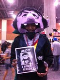 A man dressed as Count von Count poses with a Little Vampires plush toy