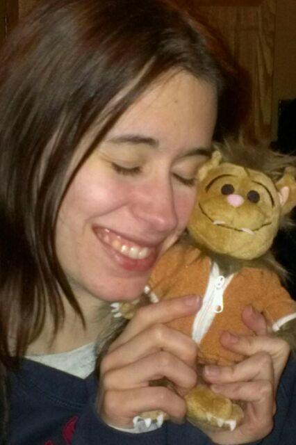 Photo of Brianna Cottrell cuddling a Wolfie plush toy