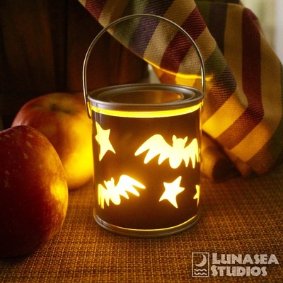 Photo of a lit mini paint bucket lantern featuring bats