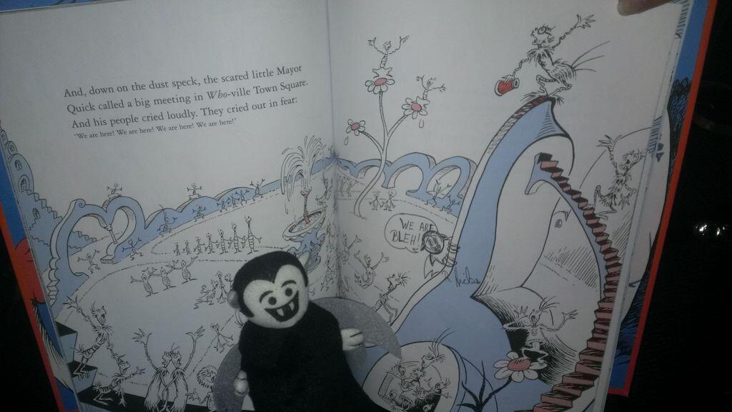 Photo of a Little Vampire in front of a page spread from Horton Hears a Who!