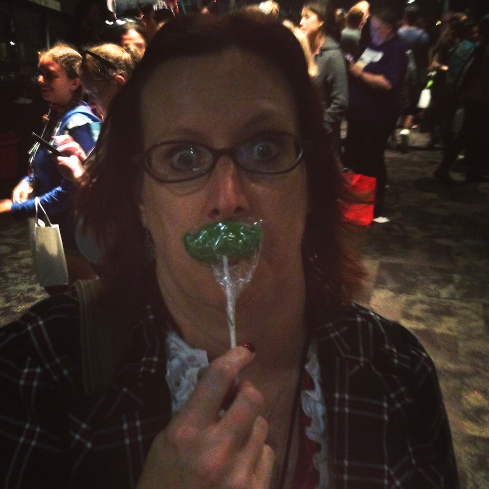 Photo of Rebecca Hicks posing with a moustache lollipop