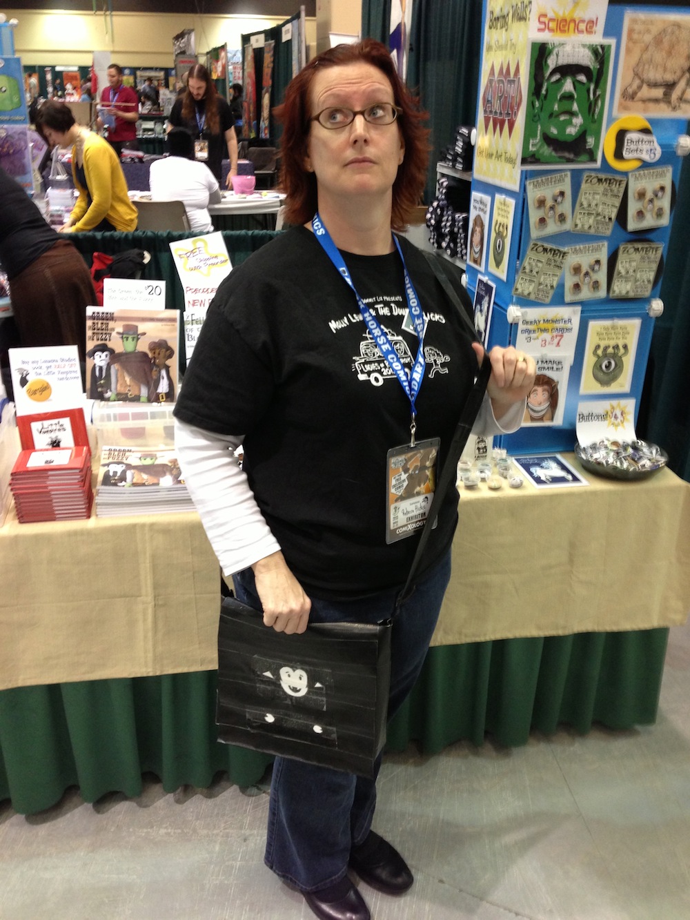 Photo of Rebecca Hicks posing with a Little Vampires art bag