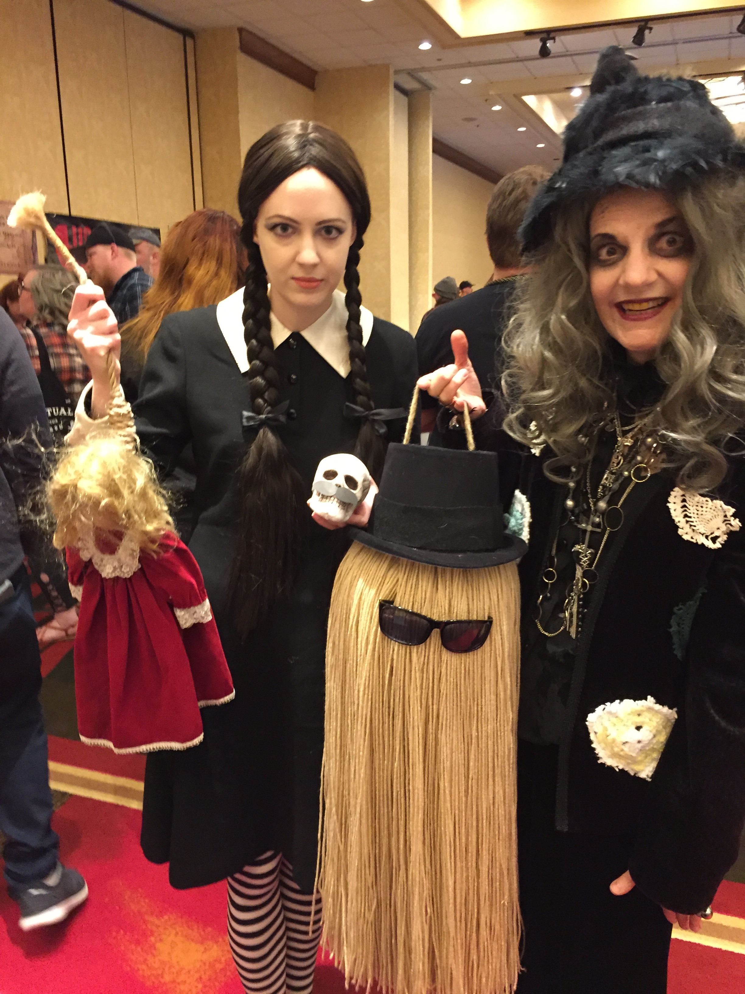 Photo of Addams Family cosplayers posing with Scott the Skull