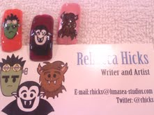 Acrylic fingernails depicting Frank, a Little Vampire, and Wolfie atop Rebecca Hicks’s business card.
