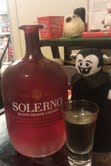 Little Vampire plush doll posing with a bottle of Solerno and a shot glass