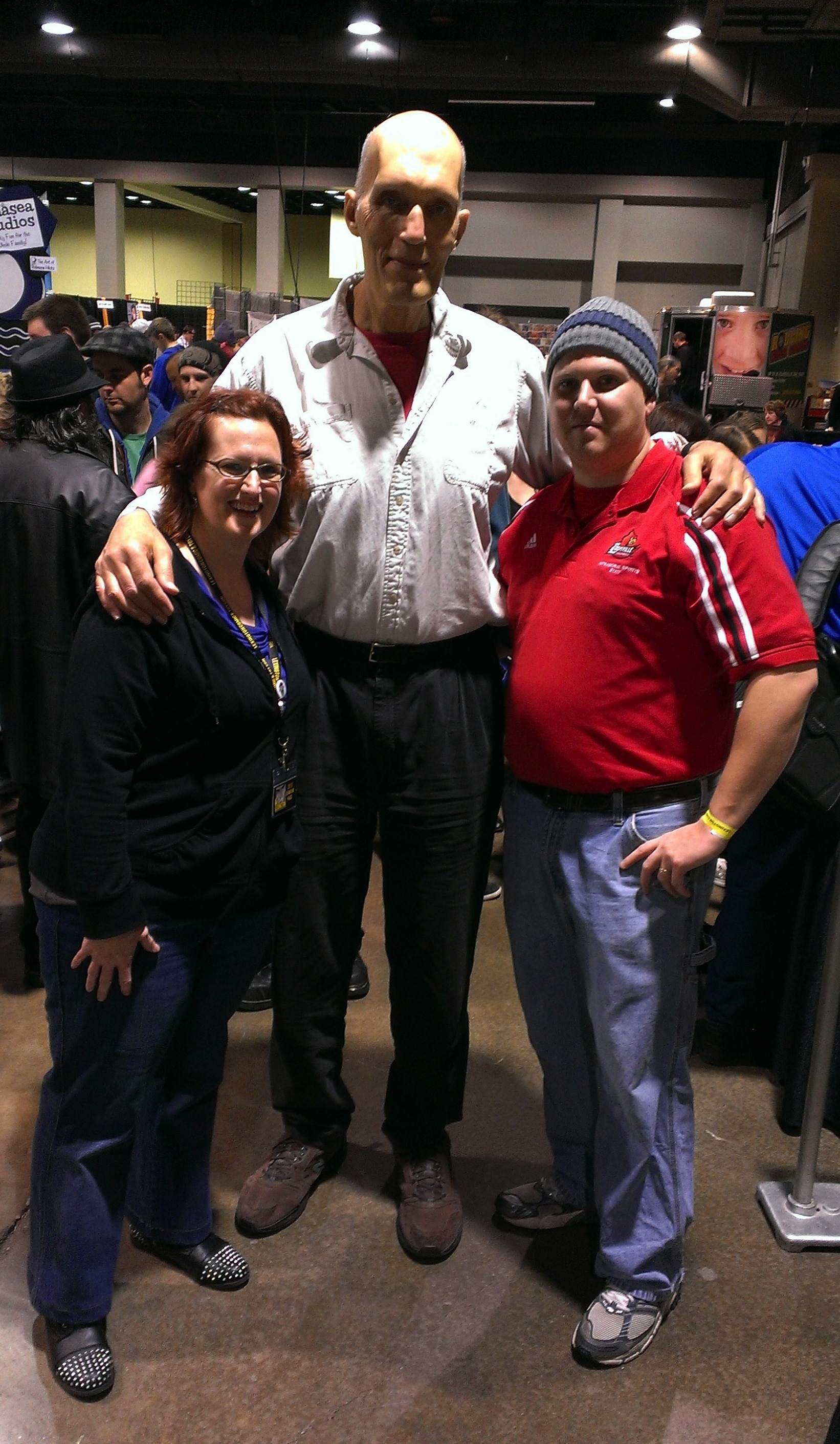 Photo of Rebecca Hicks and Thomas Farmer posing with Carel Struycken