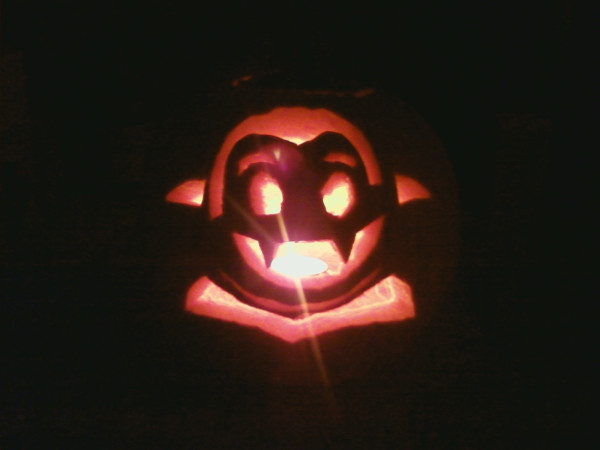 Photo of a lighted Little Vampires jack-o'-lantern in darkness, courtesy of Arin Hembd