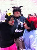 Three people in Animaniacs cosplay posing with a Little Vampire plush toy